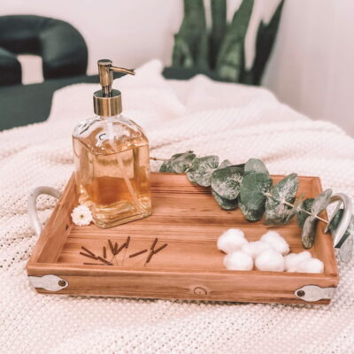 Wooden tray with dry needles, cotton balls, eucalyptus and oil